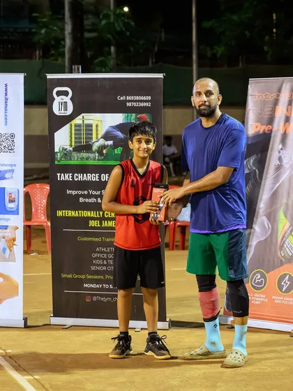 Yadnesh from Team Alphas receiving the U-11 MVP award at Hooplah '24 for his standout performance.