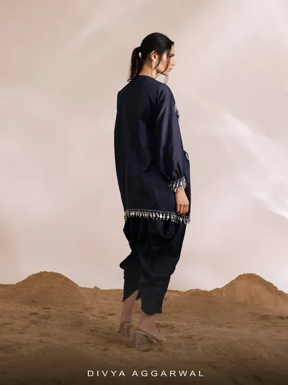 The back view of the navy Orion Kaftan Set, highlighting the tassel details on the hem and the modern cut of the dhoti pants.