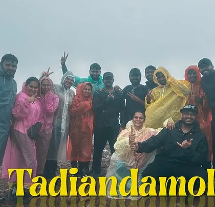 Our group at the summit of Tadiandamol, Coorg's highest peak, enveloped in monsoon clouds.