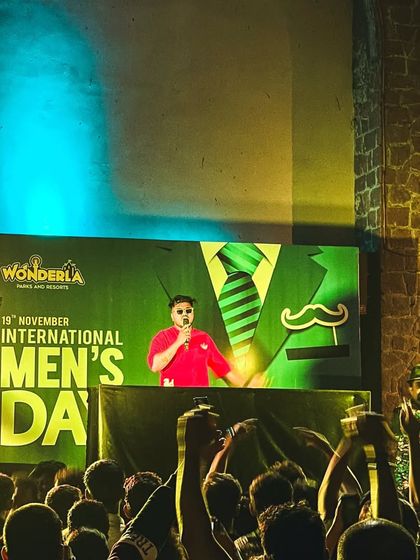 On the mic at Wonderla, hyping up the crowd. Engaging with the audience is key to creating a memorable festival experience.