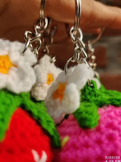 Sweet strawberry and daisy keychains. These come in red, pink, and purple, each with a little white flower.
