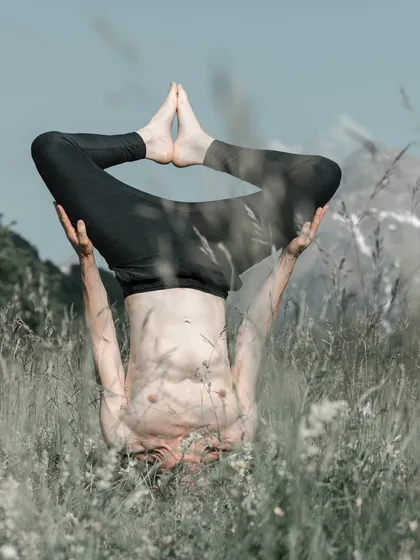 "Inverted Bliss." A stunning shot of our guest teacher Fabio Filippi holding a headstand in a field of wildflowers, capturing the serene and powerful nature of inversions.