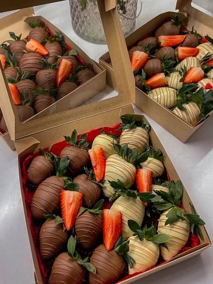 Boxes of my chocolate-coated strawberries ready for delivery. I offer them in mixed boxes with both milk and white chocolate options.