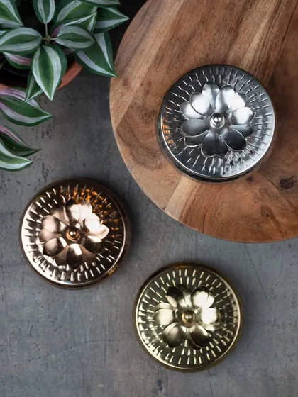 These intricately crafted metal container candles are a great gifting option for Diwali. They come in gold, silver, and rose gold finishes.