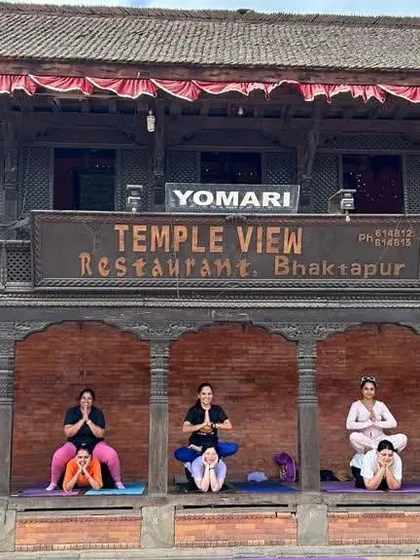 Partner yoga in front of a temple view restaurant in Bhaktapur, Nepal. We find unique and beautiful places to practice together.