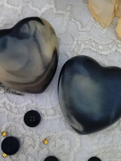 Two heart-shaped Lush Lavender soaps, each with a unique, smoky swirl pattern.