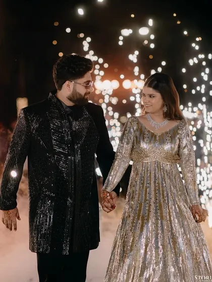 The energy of an entrance is electric. For Ronak and Garvita's celebration in Udaipur, I wanted to frame the moment they walked into their future, surrounded by light and the cheers of their loved ones.