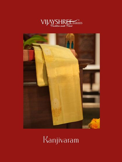 A soft yellow Kanjivaram with subtle butta work, a perfect choice for daytime functions.