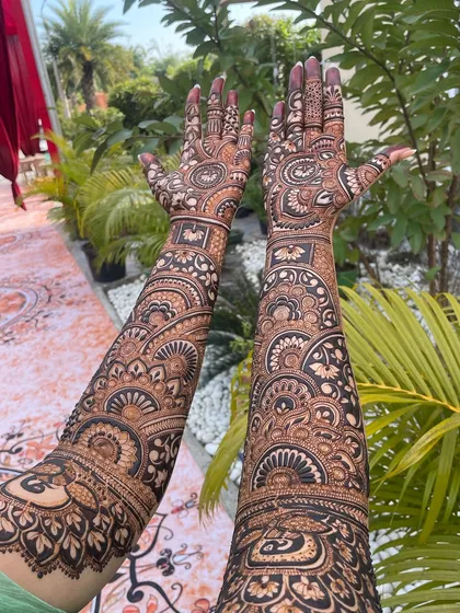 A view of the full-sleeve mehandi from a different angle, showing the artwork in all its glory.