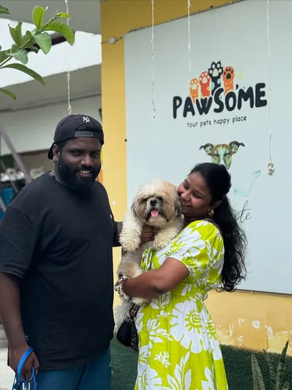 Nothing beats the joy of seeing your fur baby after their own little happy vacation. This couple is all smiles.