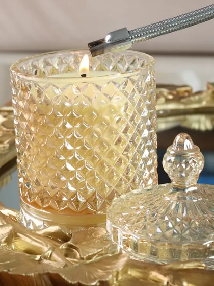 A golden glow from our Crystal Cove candle, placed on an ornate gold mirror tray. This combination creates a beautiful play of light, perfect for adding a touch of glamour.