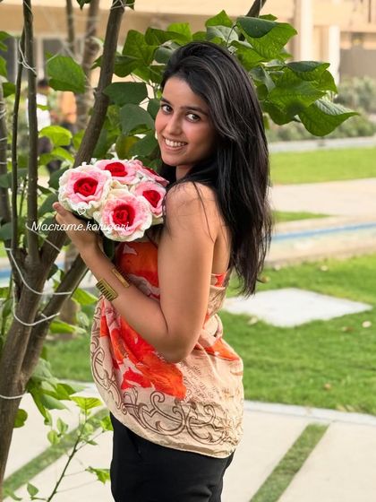 A happy moment holding a bouquet of our dual-toned pink and white crochet roses. These flowers are designed to bring joy and last forever.