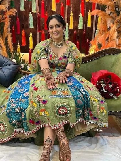 A full-length shot of the bride, showing how our intricate foot mehndi completes her stunning bridal look.