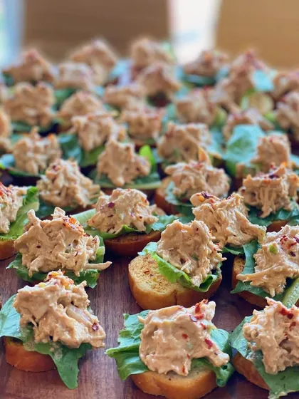 A close-up of our delicious chicken salad crostini. The creamy, seasoned chicken on a crisp slice of bread is a simple yet satisfying appetizer for any occasion.