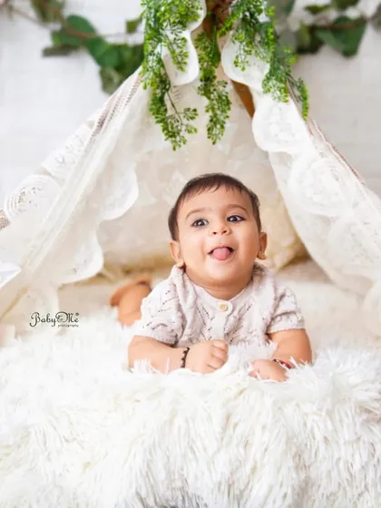That little tongue-out expression is just too cute. This six-month session in the boho teepee is full of personality.