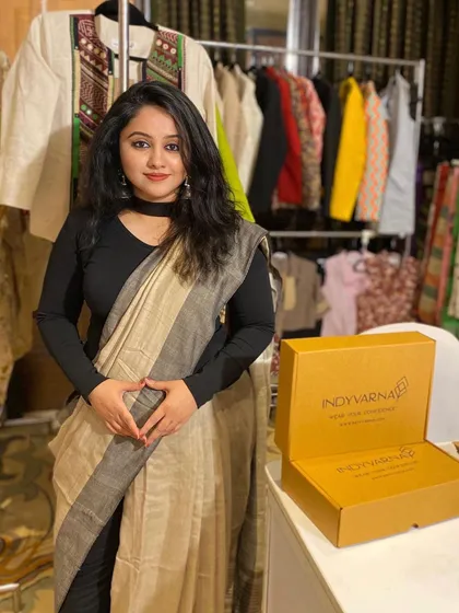 A behind-the-scenes look at an Indyvarna pop-up. You can see our clothing racks filled with Indo-western styles and our signature packaging, all designed to help you wear your confidence.