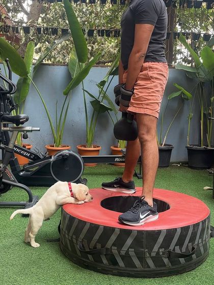 We monitor every rep. Our furry friend makes sure this member keeps his form in check during kettlebell deadlifts.