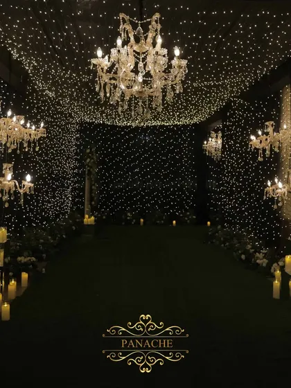 Inside the fairy light tunnel, we placed elegant crystal chandeliers to add a touch of classic glamour to the magical, starry ambiance.