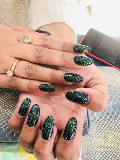 A unique look using a black base with a multi-colored flaky top coat that gives a galaxy effect.