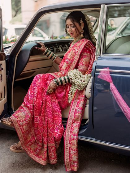 A modern Maharani making her entrance. The soft glam makeup ensures she looks flawless and feels confident, even in candid moments like this.