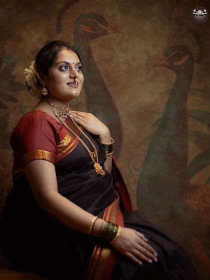 A variation of the fine-art portrait, this image incorporates a subtle peacock motif in the background, adding a unique artistic element to the traditional maternity shot.