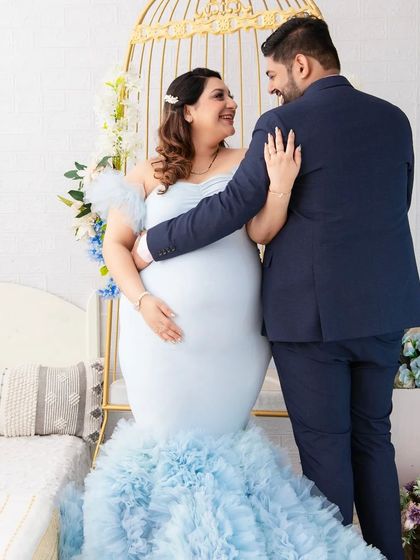 A candid moment of love and laughter. The couple shares a happy, intimate moment in our floral birdcage setting, her light blue gown adding to the fairy-tale feel.