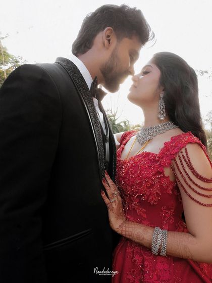 A close-up, intimate portrait of the couple. The focus is on their connection and the sophisticated details of their reception look.