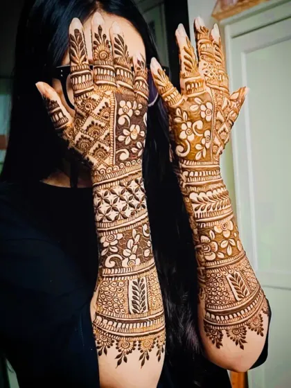 A side view of the same engagement-style mehandi, showing the design's flow and coverage on the arms.