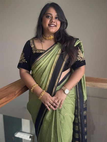 A close-up of the client, looking confident and stylish in her Dhavala saree.
