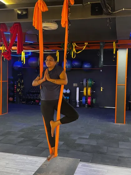 Finding balance and stillness in the air. This supported tree pose (Vrikshasana) in the hammock challenges your stability and focus in a completely new way.