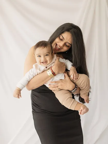 A mother and her 6-month-old son share a moment of pure joy.