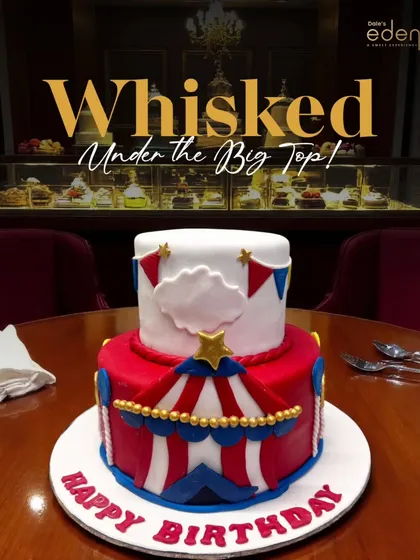 Whisked under the big top! This vibrant, two-tier circus-themed cake is decorated with red and white stripes, stars, and bunting, bringing all the fun of the circus to a birthday celebration.