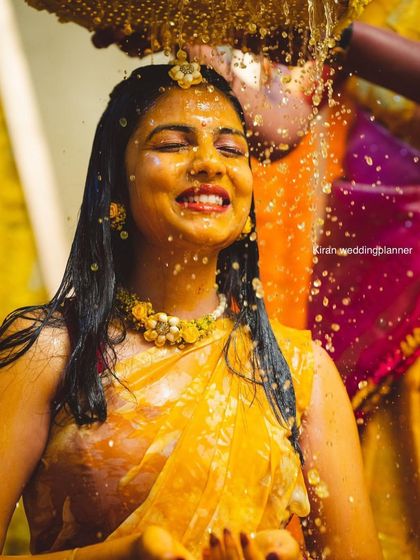 A candid shot capturing the pure joy of a bride during her Haldi ceremony, complete with fresh flower jewelry that I also provide.