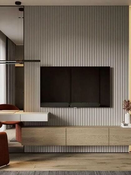 This multi-functional wall unit combines a TV display with a sleek, integrated desk. The design is perfect for a studio apartment or a living room where a dedicated office space is needed.