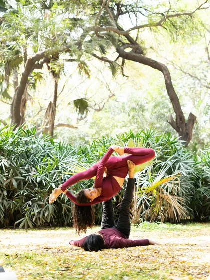 A variation of the side-star pose, showcasing the flyer's open posture and the base's solid foundation.