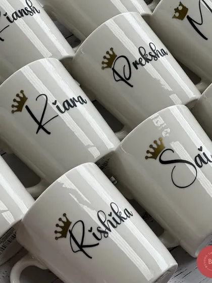 A closer look at the elegant script and crown detail on our personalised white mugs.