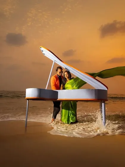 A grand piano on the beach at sunset. We believe in creating surreal and unforgettable concepts for your save the date or pre-wedding shoot, making your announcement truly stand out.