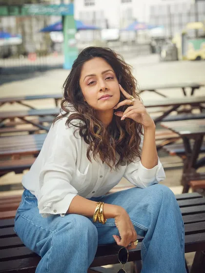 A more serious and editorial pose, showing how a simple denim look can be elevated with the right attitude and accessories.