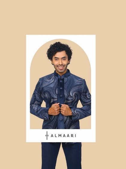 A model looking effortlessly cool in a blue textured bandhgala jacket. This is a great alternative to a traditional blazer for a cocktail or sangeet night.