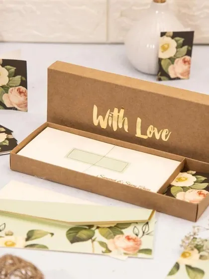 Personalized stationery makes for a timeless and elegant wedding favor. This set includes custom floral-themed envelopes, note cards, and gift tags, all presented in a beautiful box with "With Love" embossed in gold foil.