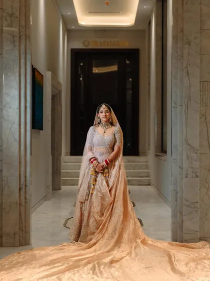 A majestic full-length shot of the bride. The makeup is designed to be stunning from afar, creating a grand and elegant bridal entry.