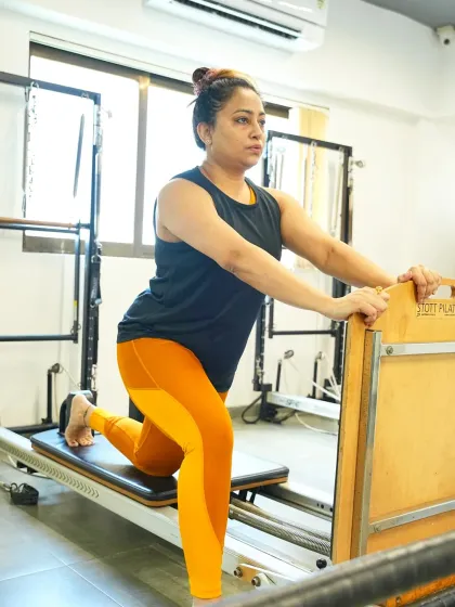 A deep lunge on the reformer helps to open the hips and strengthen the legs. This is a journey of mindful movement, where every breath supports the exercise.