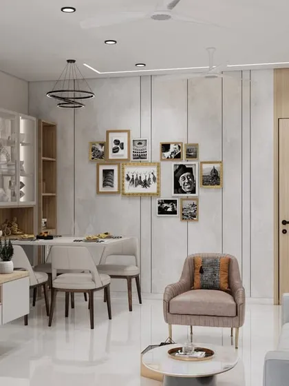 This angle shows the TV unit and a gallery wall for personal photos, making the house feel like a home. The layout seamlessly integrates the dining and living areas for maximum functionality.