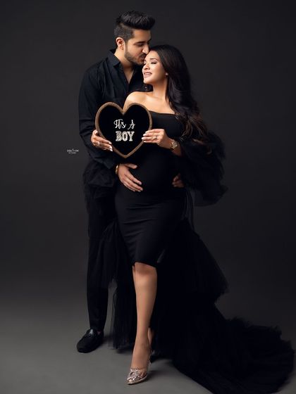 Learn how to incorporate fun props and gender reveal elements into your shoots. This shot from a workshop shows a happy couple announcing their baby boy.