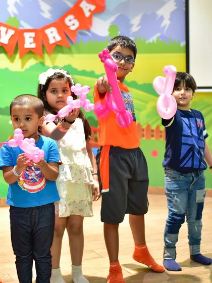 Kids proudly showing off their balloon animal creations. Balloon twisting is a fun, interactive activity for any party.