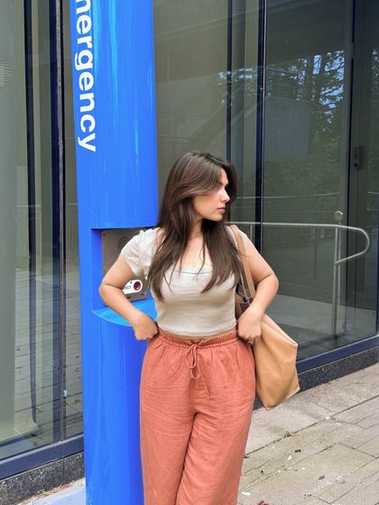 A candid moment adjusting the pants of my outfit.