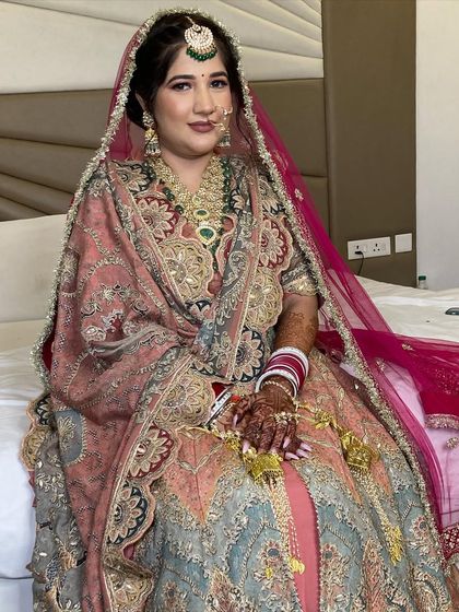 The complete look for my Anand Karaj bride. The pastel-colored, heavily embroidered suit is the star, supported by clean and subtle makeup.