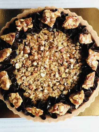 This overhead shot captures the beautiful contrast between the dark, silky chocolate and the golden, crunchy almond topping.