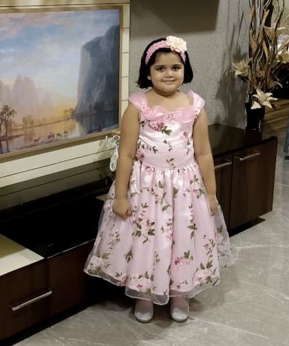 Ready for her birthday spotlight in this beautiful floral gown. The dress features a satin bodice with delicate floral details and a full organza skirt, designed to make her feel like the star of the show.