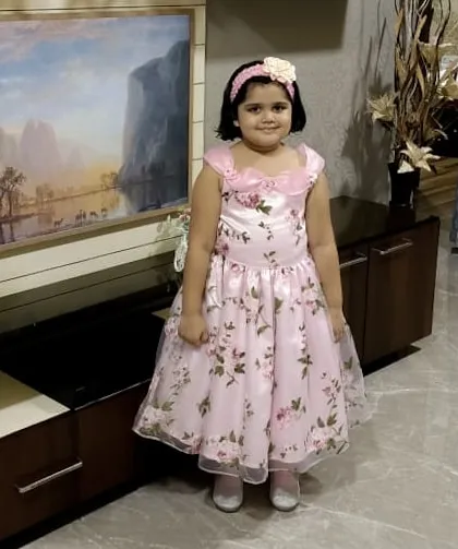 Ready for her birthday spotlight in this beautiful floral gown. The dress features a satin bodice with delicate floral details and a full organza skirt, designed to make her feel like the star of the show.